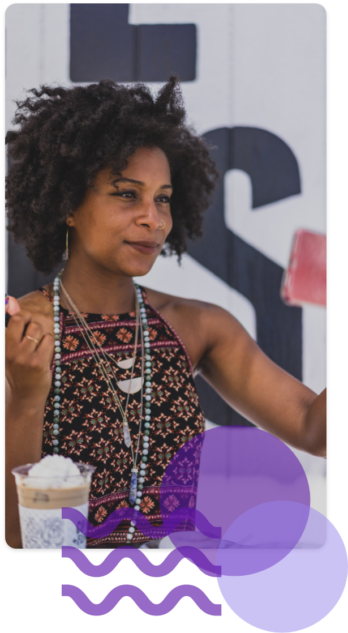 African American woman smiling taking a selfie.